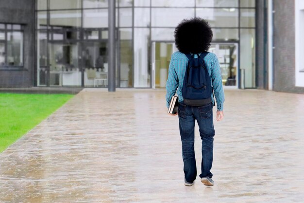 Afro student walks at school yard