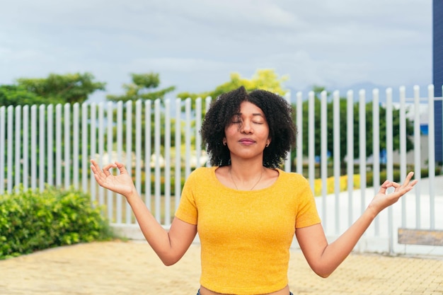 Afro vrouw mediteren in een park