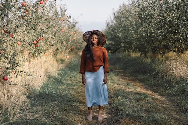 Afro woman in Apple trees orchard