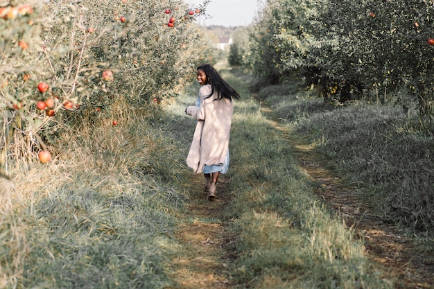 Afro woman in Apple trees orchard