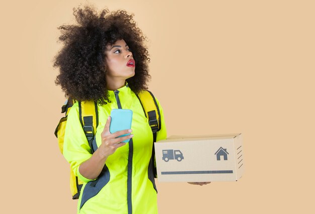 Afro woman delivery girl with package, backpack, and smartphone