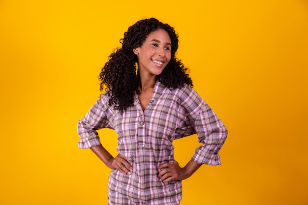 Afro woman dressed in June party clothes and hair tied by maria chiquinha