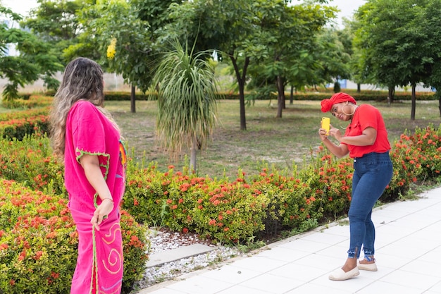 Afro Woman Filming Her Friend Dancing