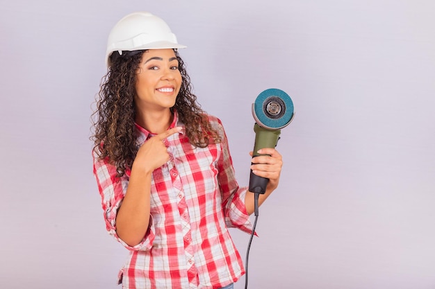 Afro woman holding an electric sander. building material concept