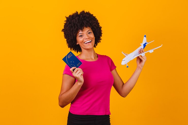 Afro woman holding a toy airplane and brazilian passport. Travel conceptafro woman holding a toy airplane and brazilian passport. Travel concept