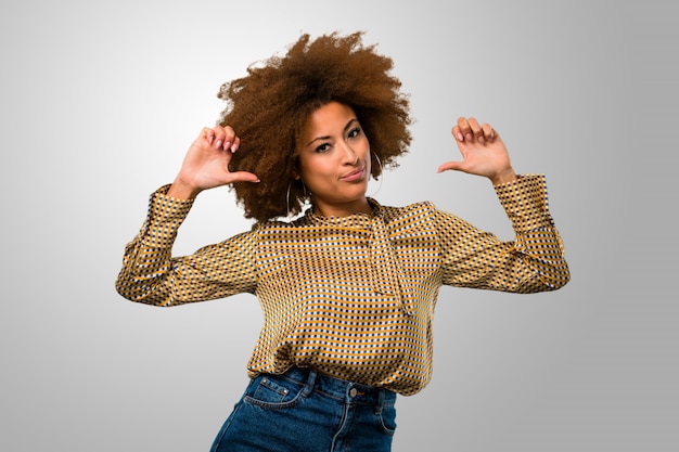 Afro woman pointing herself