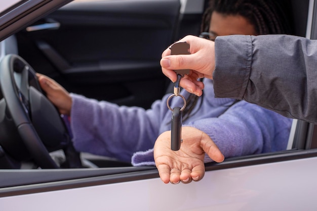 Afro woman receiving the keys of her new car