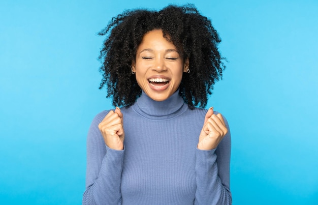 Photo afro woman screaming celebrating victory win success  rejoicing triumph feeling winner