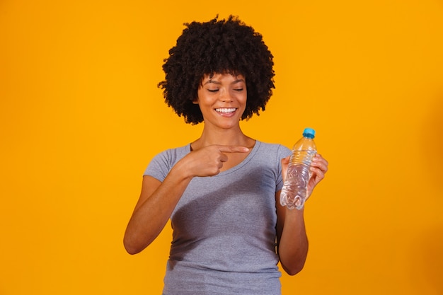 Afro woman with bottle of water