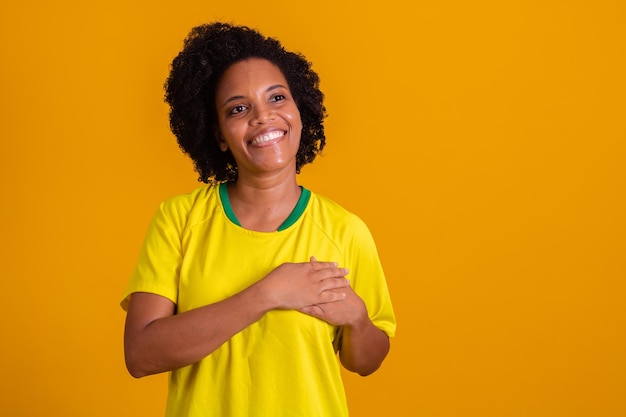Afro woman with hand on heart with sign of gratitude and patriot September 7 Independence of Brazil