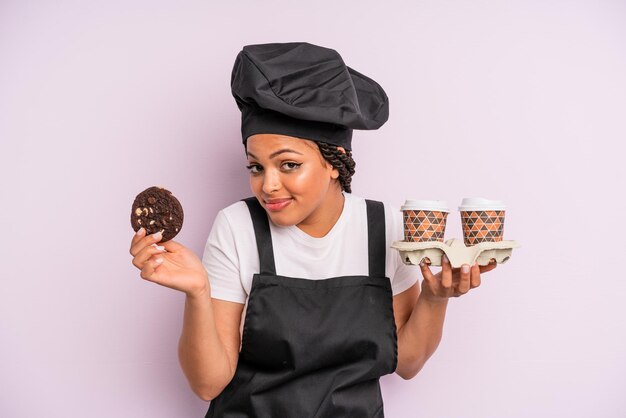 afro zwarte vrouw chef-kok met vlechten en een koekje maken