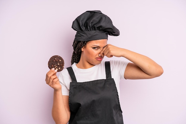Afro zwarte vrouw chef-kok met vlechten en een koekje maken