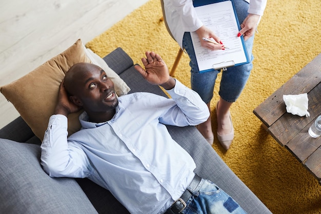 Afroamerican man sharing his problem with psychologist