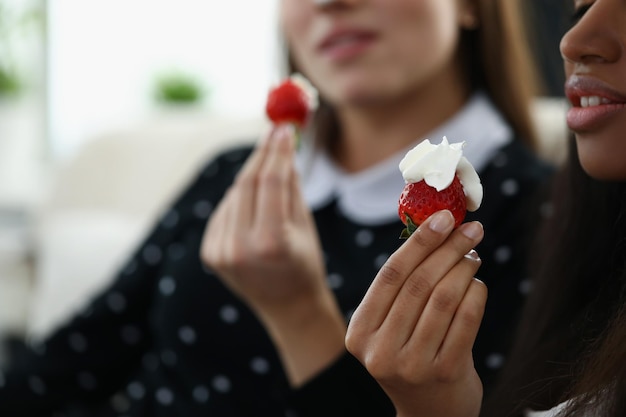 Afroamerican young woman hold strawberry with whipped cream