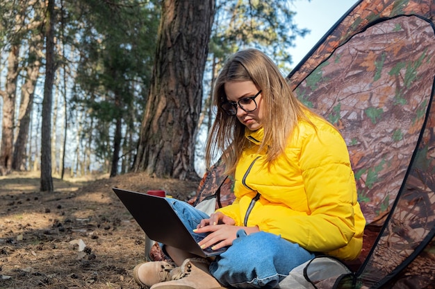 Afstandsonderwijs online onderwijs en werk vrouw meisje werken kantoorwerk op afstand vanuit bos sitt