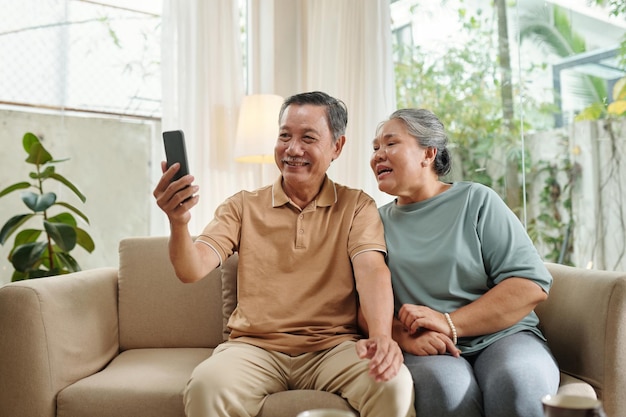 Aged Couple Video Calling Grandchildren