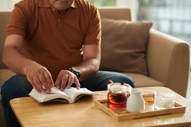 Aged Man Enjoying Reading Novel