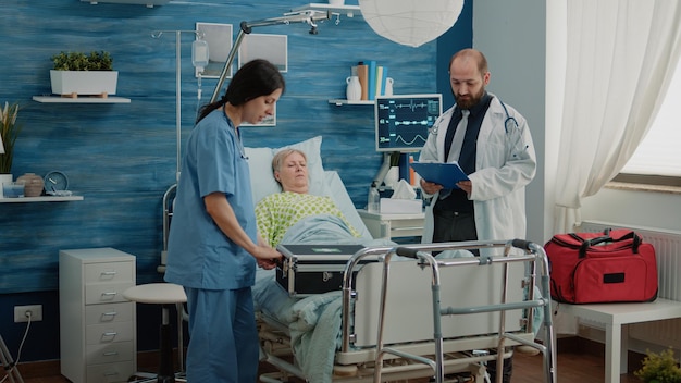 Aged patient with sickness receiving medical visit for checkup