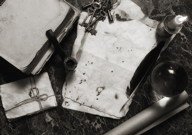 Aged retro papers and book on table with detective tools background