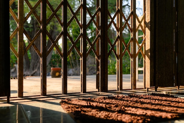 Aged of rusty asian gate with carpet