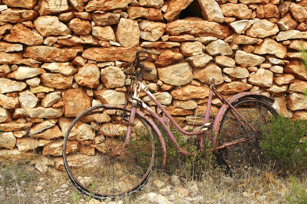 Aged weathered bicycle vintage stone wall