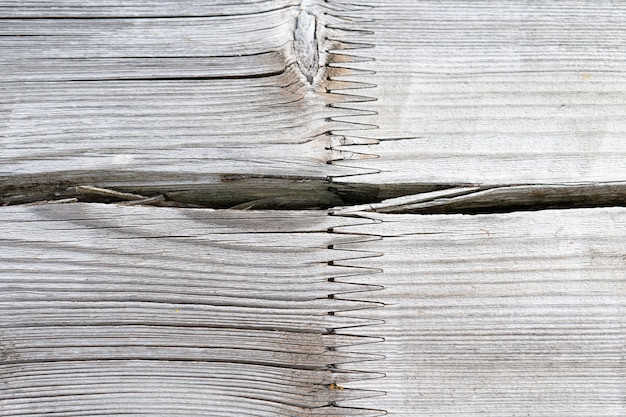 Aged white wood with cracks background texture