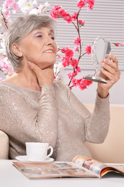 Aged woman looking in mirror