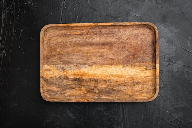 Photo aged wood cutting board set, top view flat lay , with copy space for text or your product, on black dark stone table background