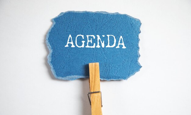 Agenda text on paper with clamp on table