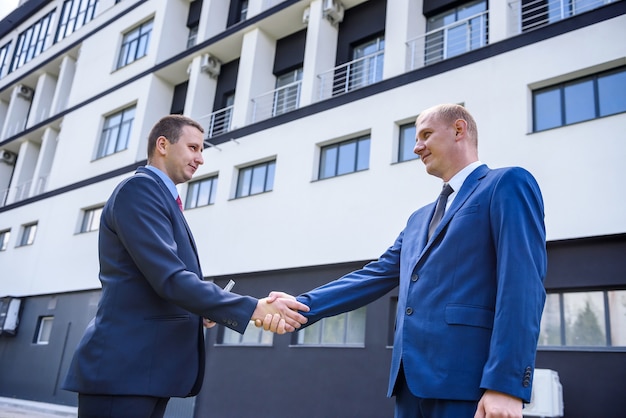 Agent with buyer posing on construction site