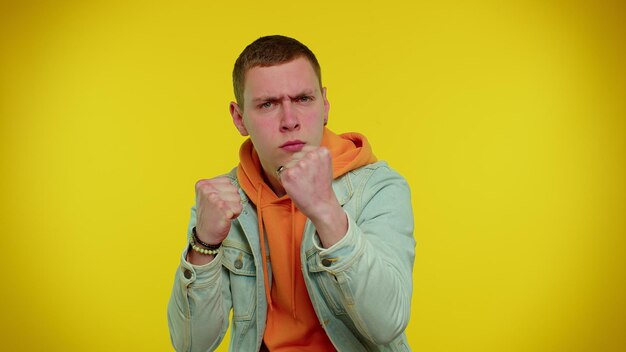 Aggressive angry man trying to fight at camera shaking fist boxing with expression punishment