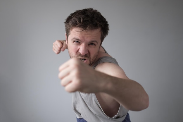 Aggressive man showing his fist Domestic violence and harassment during staying home