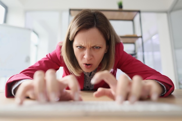 Aggressive worker stretches out hands typing on keyboard