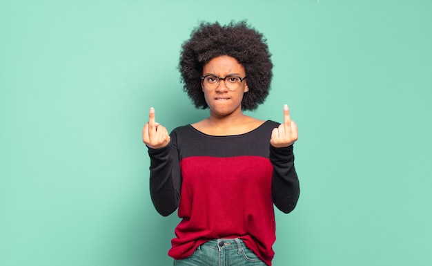 Aggressive young pretty black woman showing his middle finger