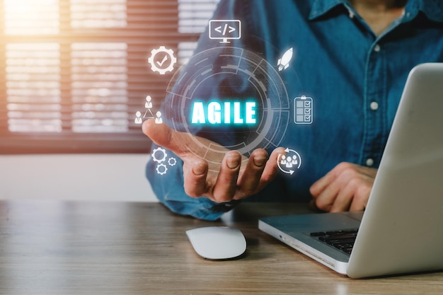 Agile development methodology concept Business person using laptop computer and hand holding VR screen Agile icon on office Technology concept