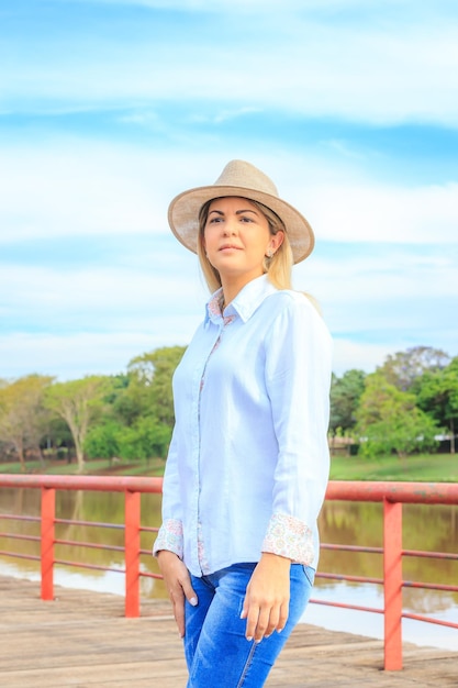 Agribusiness woman wearing hat and jeans at the end of a working dayxA