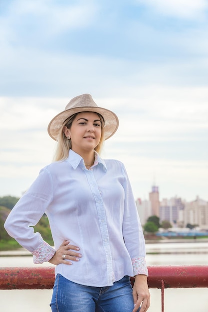 Agribusiness woman wearing hat and jeans at the end of a working dayxA