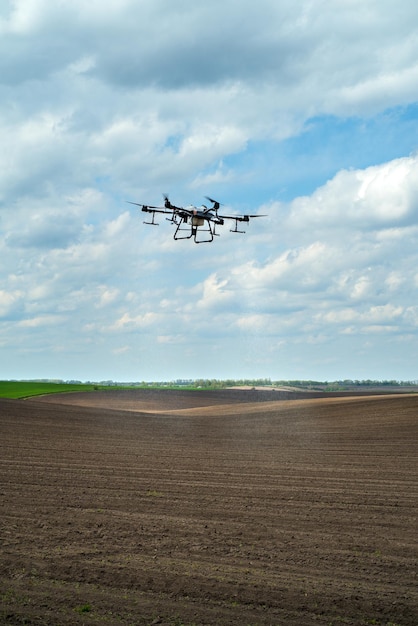 Agricultural drone for precise application of fertilizers and pesticides modern agriculture automatic drone over the field