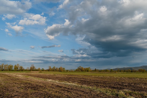 Agricultural field before planting with scenic sky at spring Landscape nature