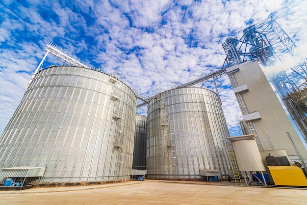 Agricultural industrial background. Huge metal grain silos in the inductrial zone.