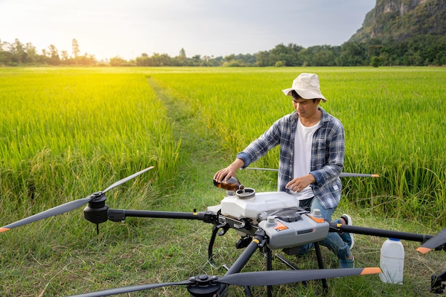 Agricultural specialist or Famer are filling chemical fertilizers in agriculture drone Agriculture 5g Smart farming Smart technology concept