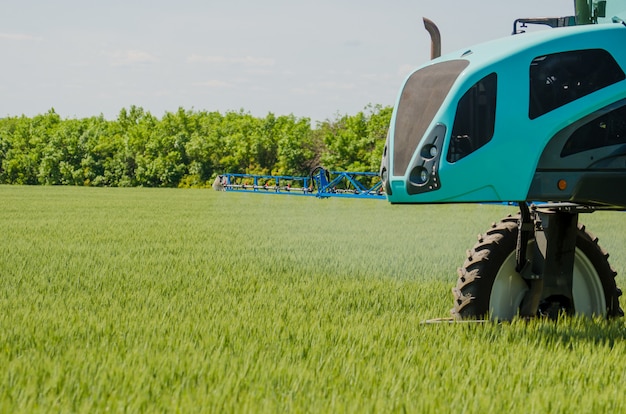 Agricultural sprayers, spray chemicals on young wheat.