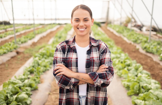 Agriculture farming and woman farmer in a greenhouse with sustainable plants and pride for growth and development of eco environment Portrait of female on a farm in countryside for sustainability