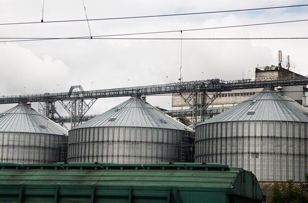 Agriculture grain silos on grass under blue sky Ukrainian wheat export of industry