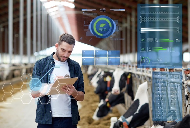 फोटो agriculture industry, people and animal husbandry concept - happy young man or farmer with clipboard and cows in cowshed on dairy farm