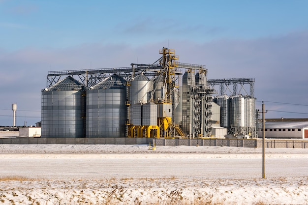 Agro silo's graanschuur lift in winterdag in besneeuwde veld Silo's op agroprocessing fabriek voor verwerking drogen, schoonmaken en opslag van landbouwproducten meel granen en graan