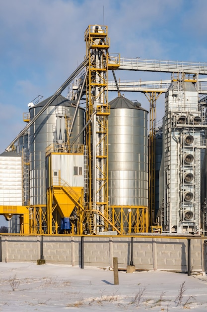 Agro silo's graanschuur lift in winterdag in besneeuwde veld Silo's op agroprocessing fabriek voor verwerking drogen, schoonmaken en opslag van landbouwproducten meel granen en graan