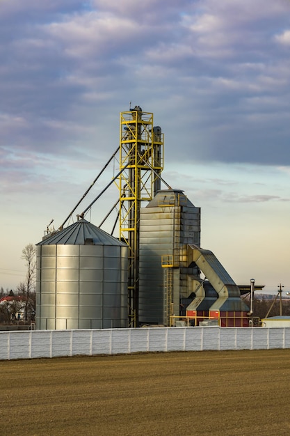 Agro silos granary elevator silos on agroprocessing\
manufacturing plant for processing drying cleaning and storage of\
agricultural products flour cereals and grain