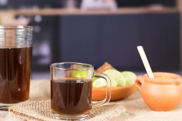 Agua de panela or sugar cane sweets and lemon in the kitchen typical food of Colombia