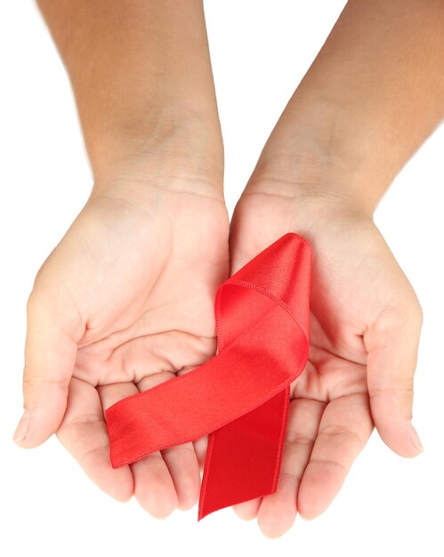 AIDS ribbon in hands isolated on white